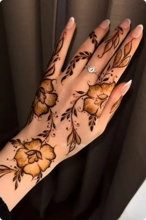 A woman's hand displaying beautiful henna art, showcasing traditional designs.