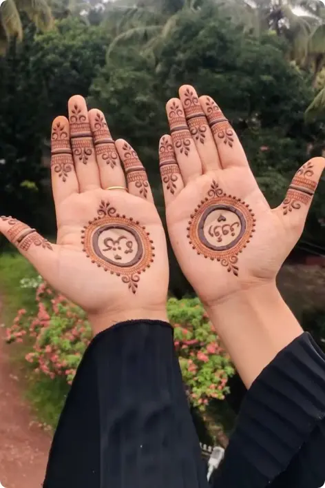 Two hands adorned with intricate custom mehndi henna designs, showcasing detailed patterns and artistry.