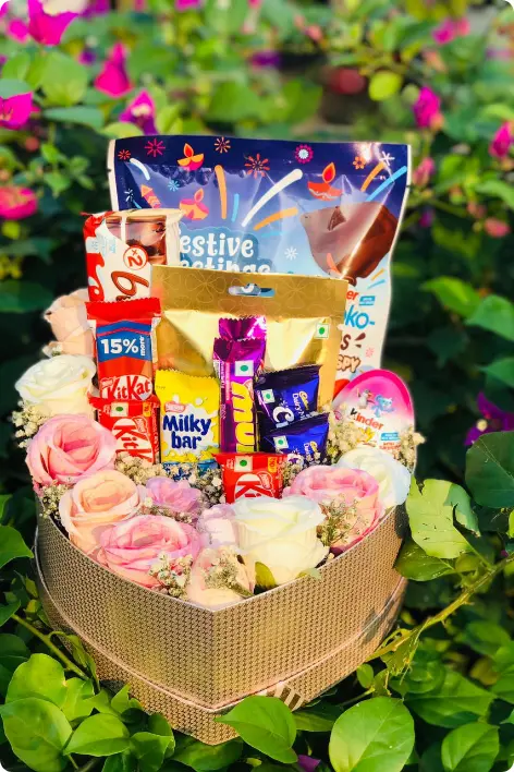 Beautiful chocolate and flower gift hamper arrangement with KitKat, Dairy Milk, Kinder Joy, and festive treats, perfect for celebrations and special occasions – Gifts Hampers in Thrissur
