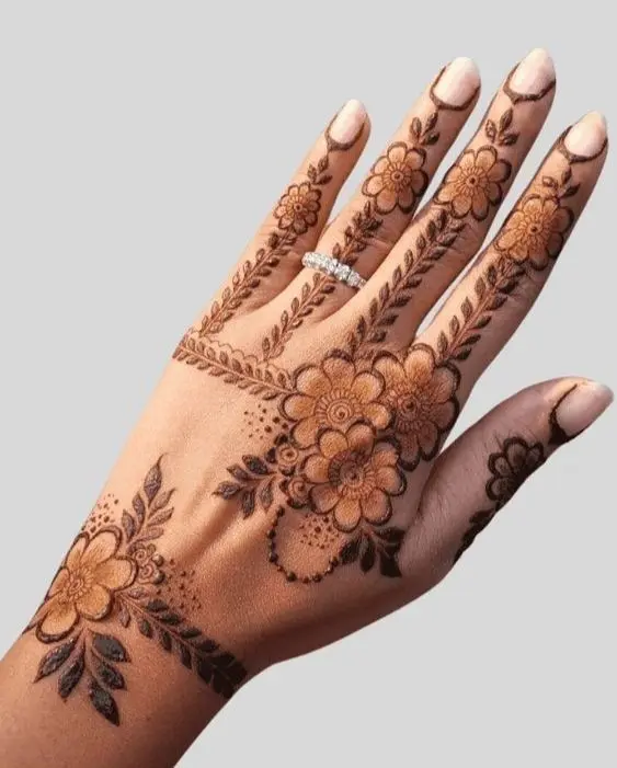 Mehndi Design Hands decorated with detailed henna designs, featuring elegant swirls and motifs, highlighting cultural artistry.<br />
