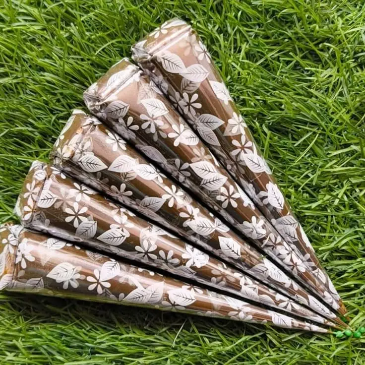  A collection of organic mehndi cones, each topped with charming white flowers, showcasing their decorative design.
